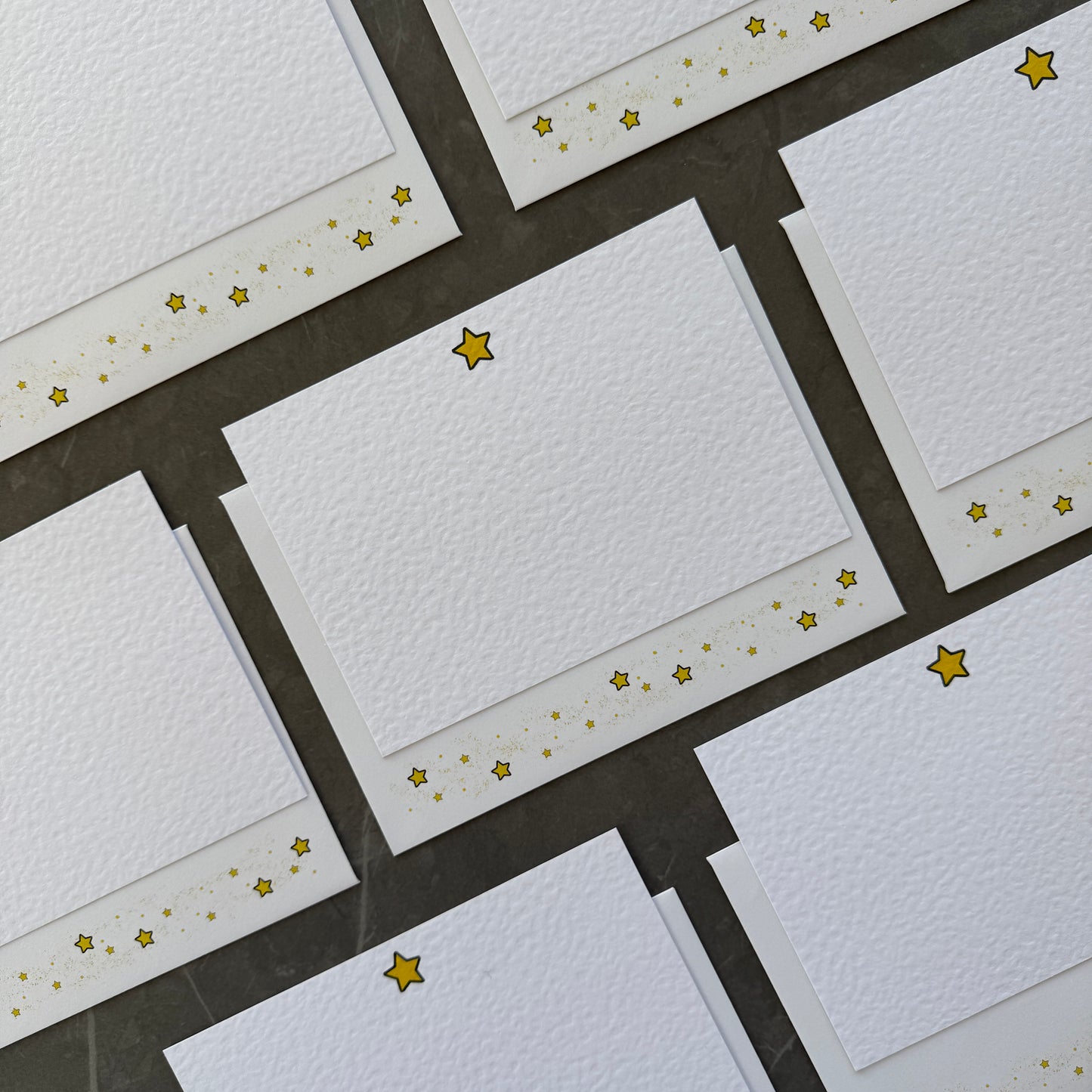 Correspondence cards with small gold star illustration at the top with matching star envelopes